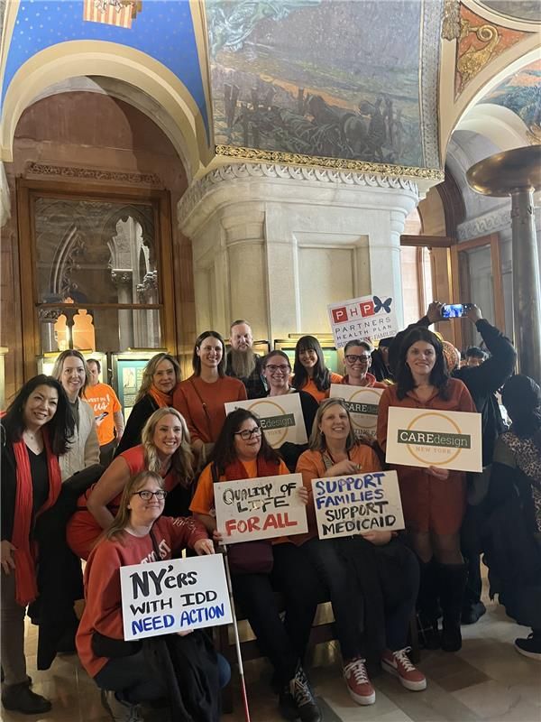 team members from Care Design New York holding signs at NYDA rally