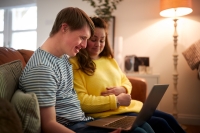 young man and woman sitting on their laptop