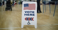 Vote here sign with disability sign