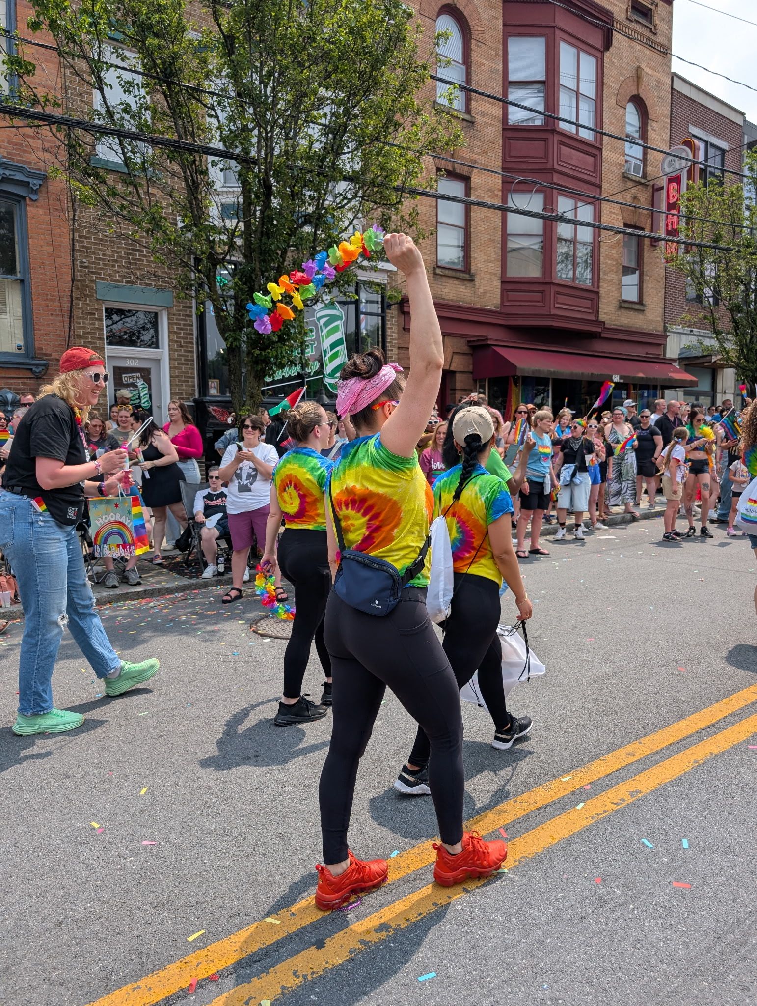 three women in rainbow tie dye shirts at Albany Pride parade