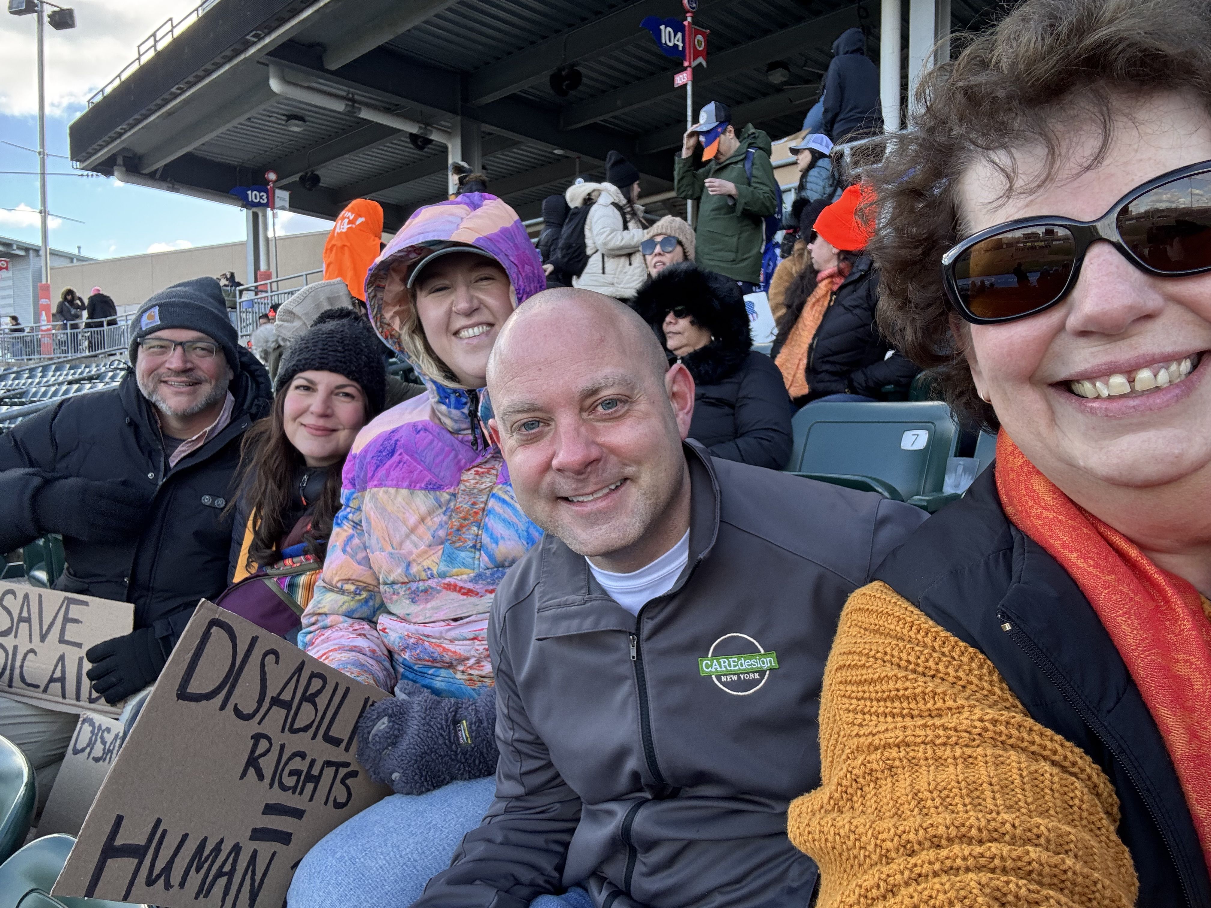 Care Design team members posing for a photo in the NY Boulders stadium